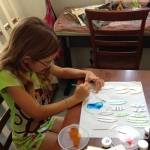 Painting designs on surfboards for Papa's cake